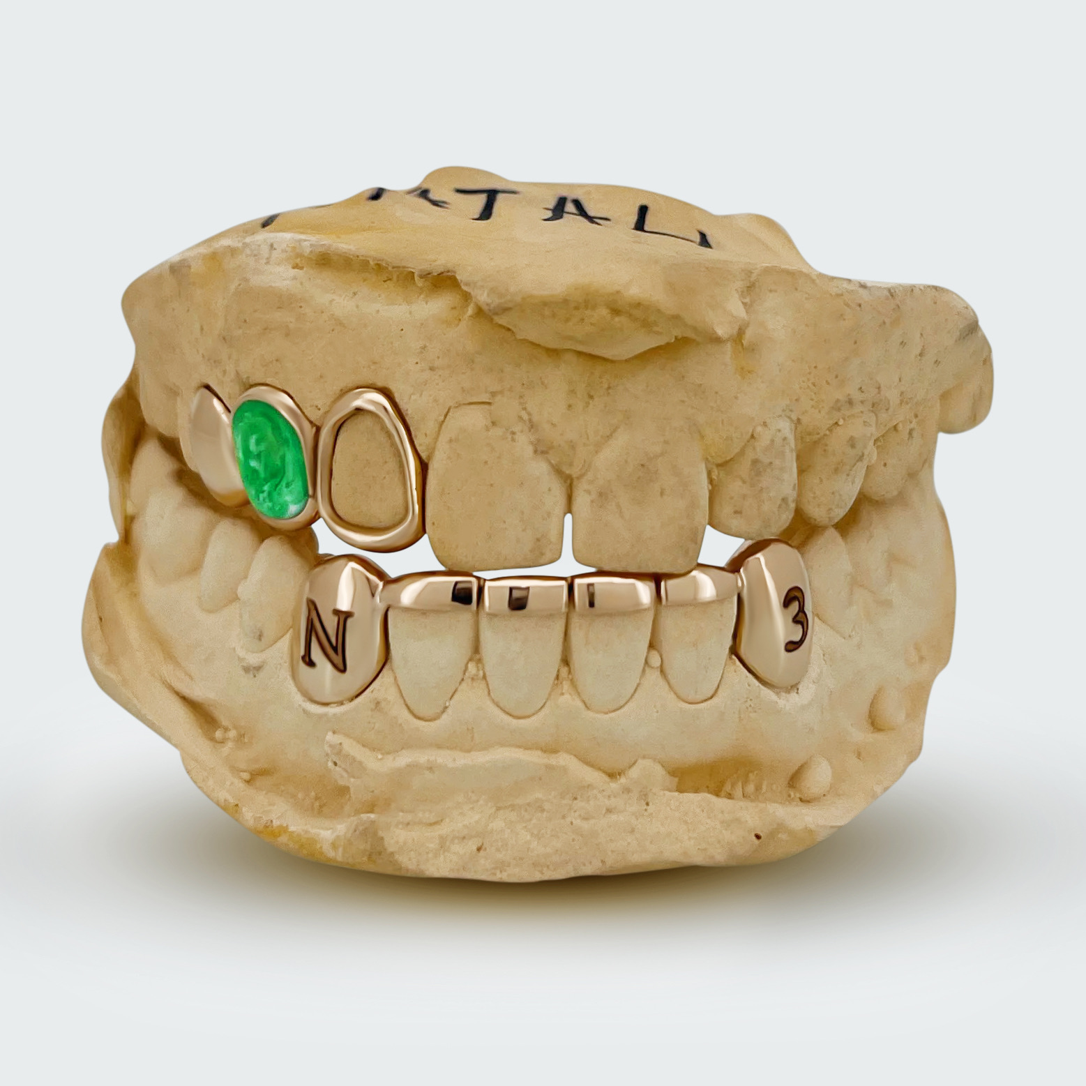 Yellow-gold grillz with green enamel detailing by Erick Kraftsman