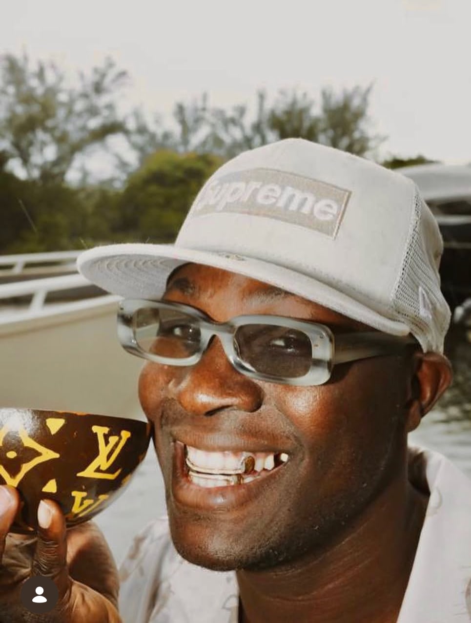 Smallgod smiling in custom Erick Kraftsman grillz
