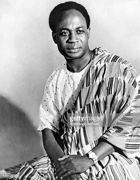 Black-and-white archival portrait of Kwame Nkrumah seated in traditional cloth